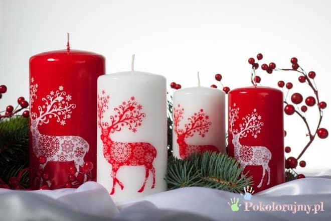 Cztery świece bożonarodzeniowe ozdobione reniferami i śnieżynkami
