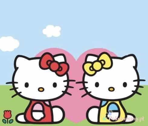 Dwie kotki w stylu Hello Kitty z czerwoną i żółtą kokardką na łące - obraz wyróżniony